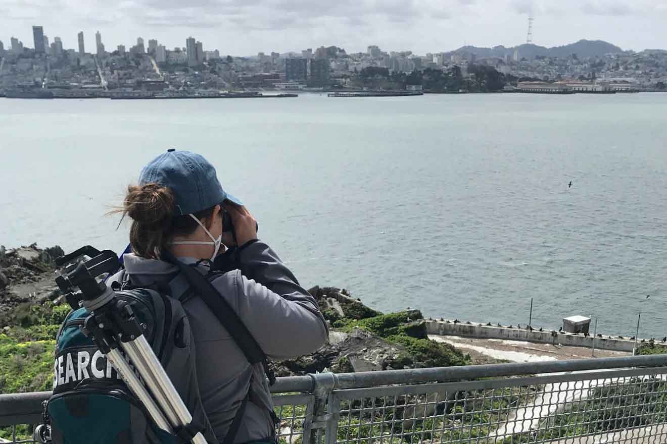 Researcher looking through binoculars on Alcatraz Island